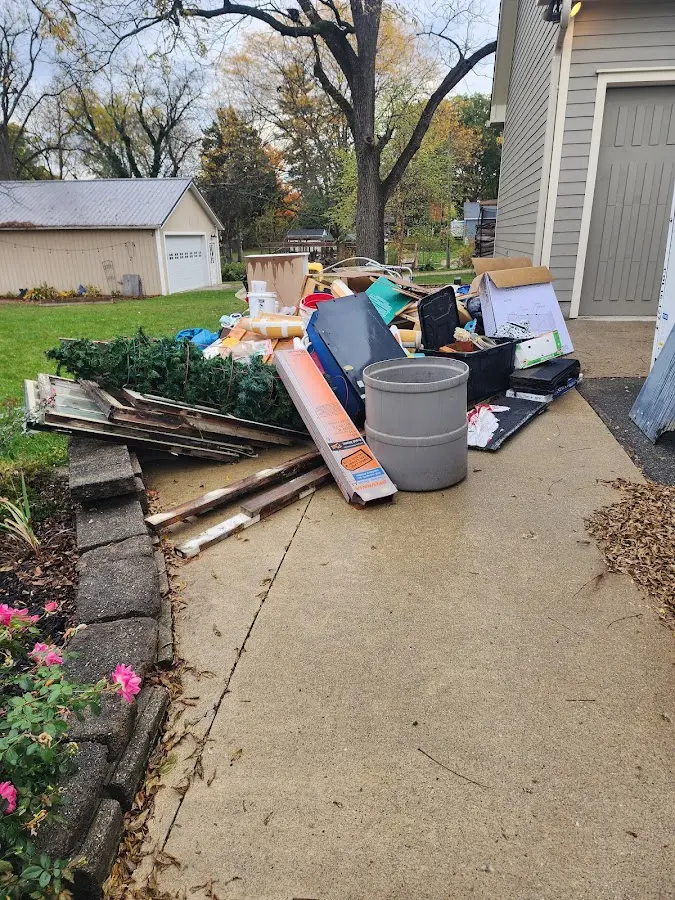 Dumpster being loaded with debris for Residential Dumpster Rental in Oasis